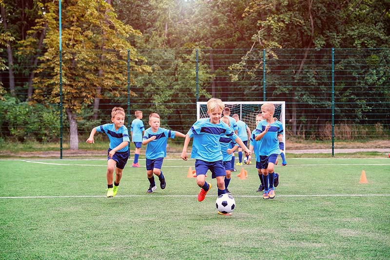 healthy children playing soccer