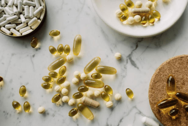 Various supplements on a countertop and on plates