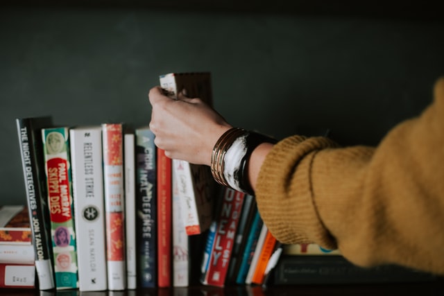 Hand reaching for a book