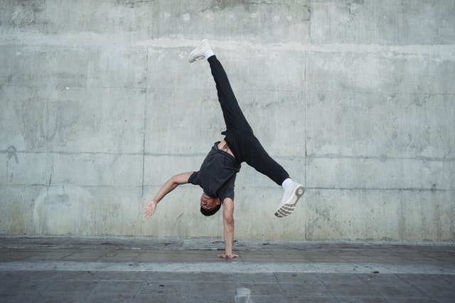 Types of Exercise: Man balancing on one hand