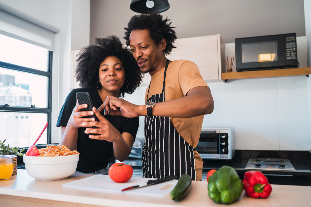 Couple cooking healthy food while traveling